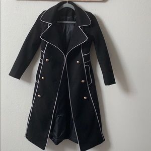 Black trench coat with white piping accent